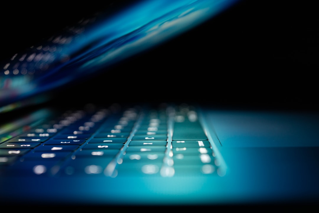 Close-up of a keyboard with a glowing blue light, representing cybersecurity and data protection